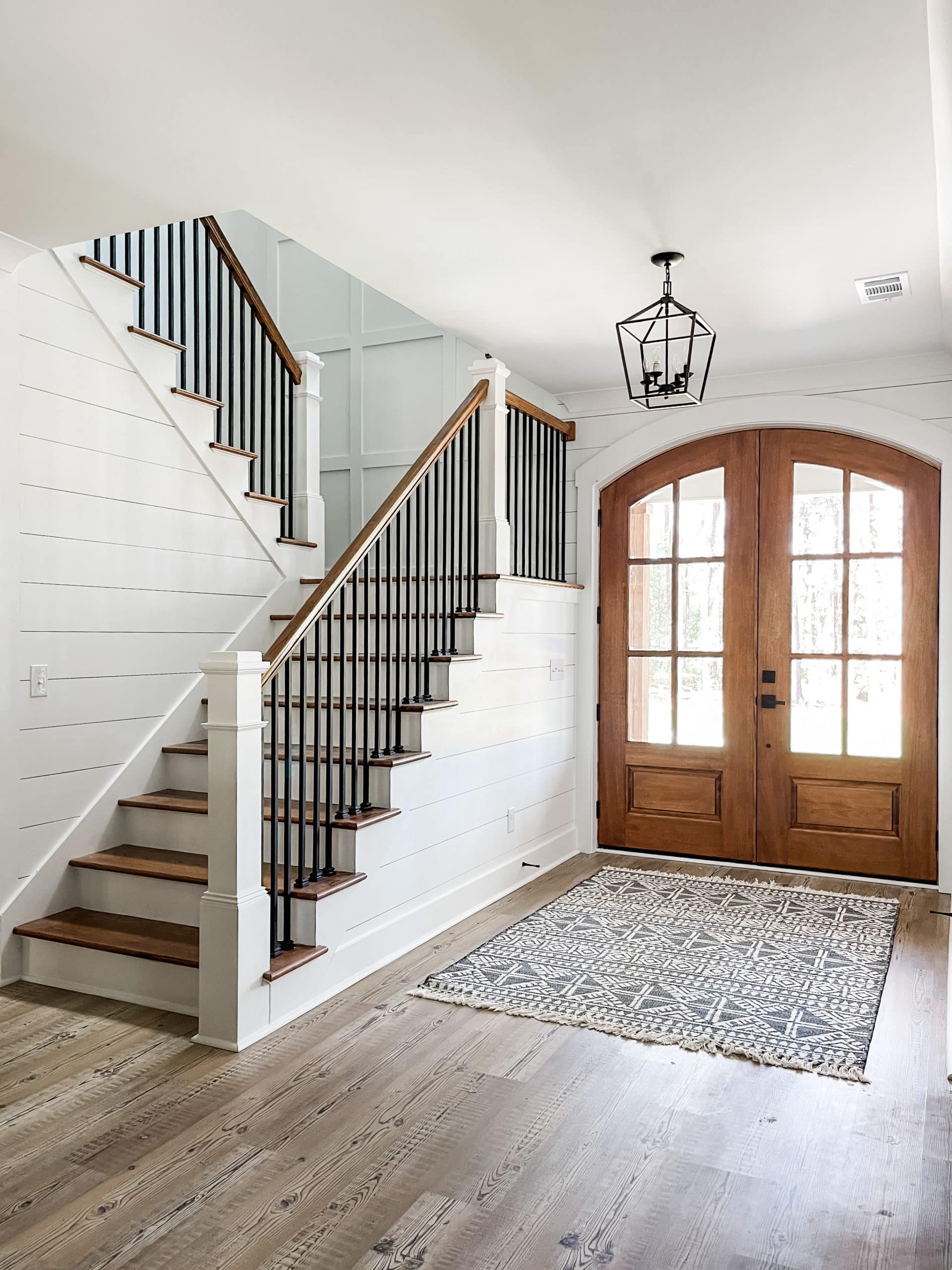 farmhouse entry way with stairs shiplap wood doors light fixture and lvp flooring judges panel