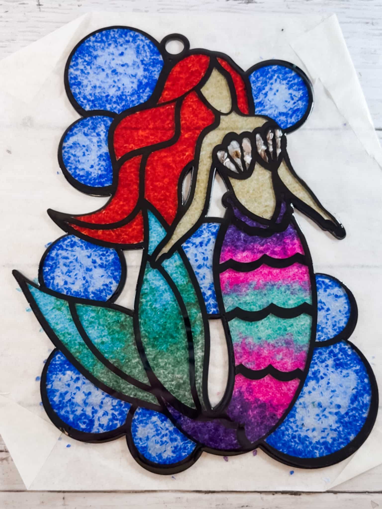 Finished Faux Stained Glass Mermaid Suncatcher with uncured resin on transfer tape