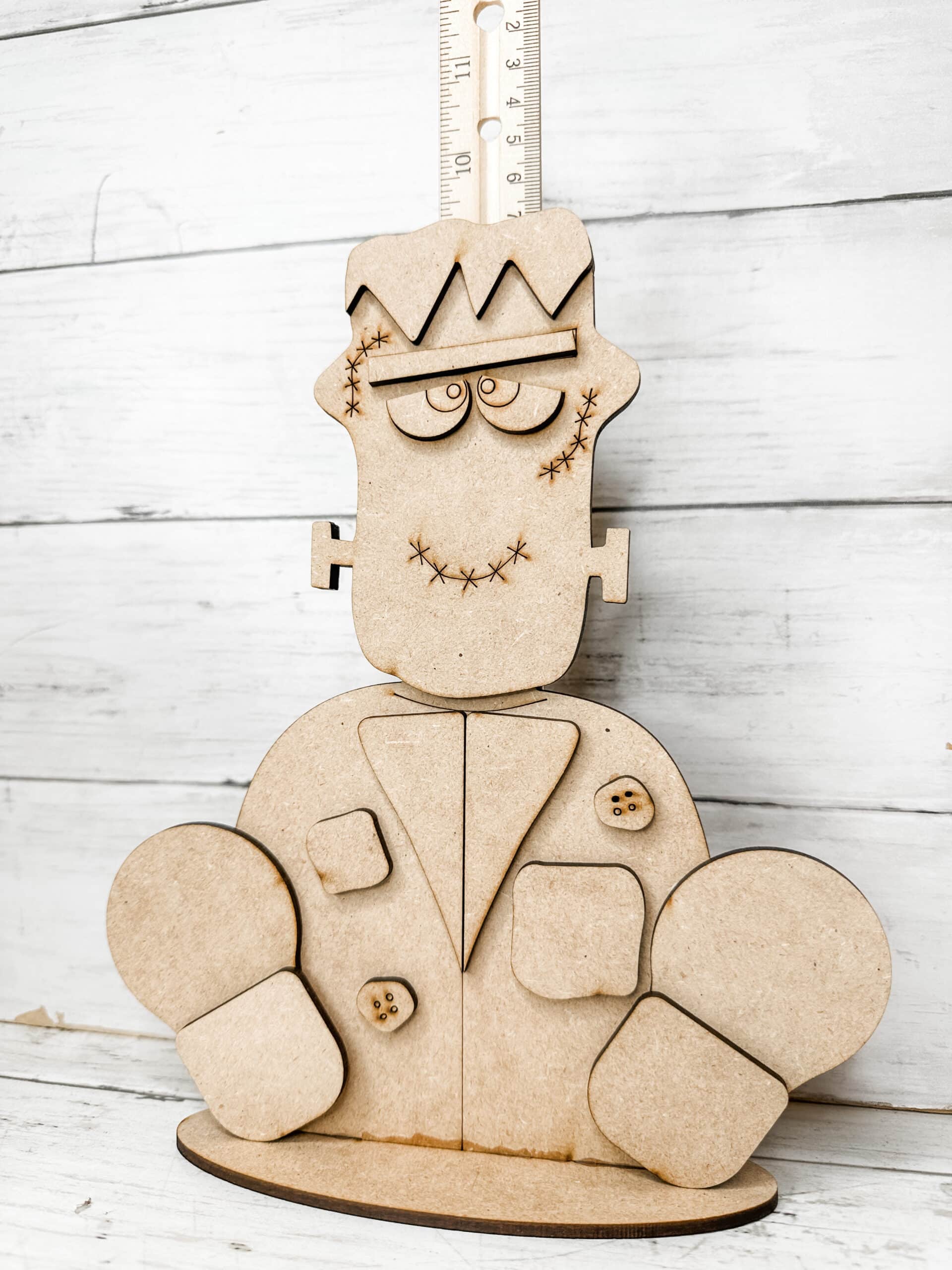 unpainted assembled frankenstein diy craft kit displayed with a ruler for size reference.